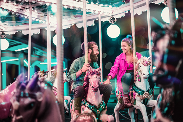 Reconnected couple enjoying carousel